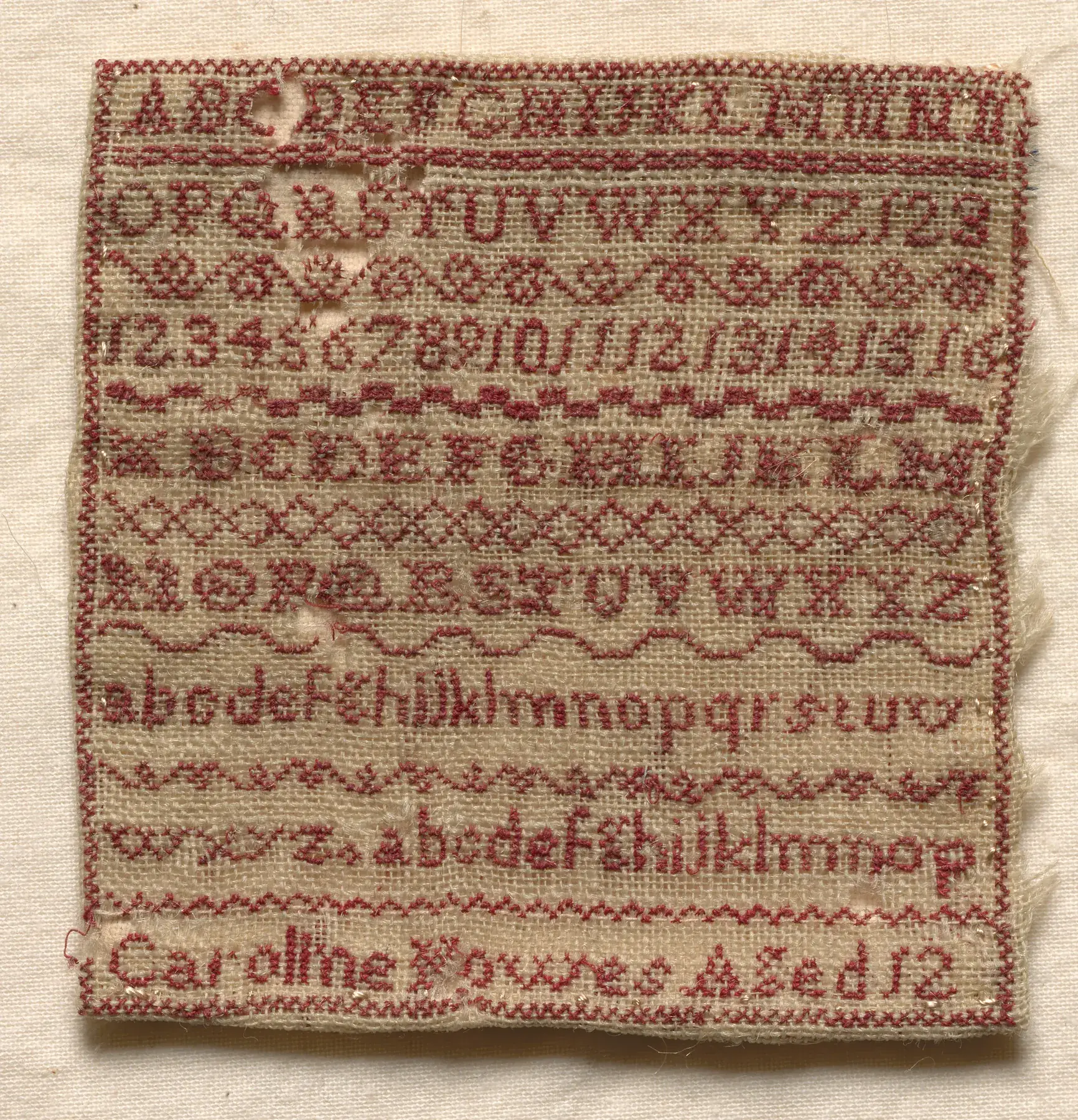 Sampler, England, 1800s — stitched square by square on a grid like this one