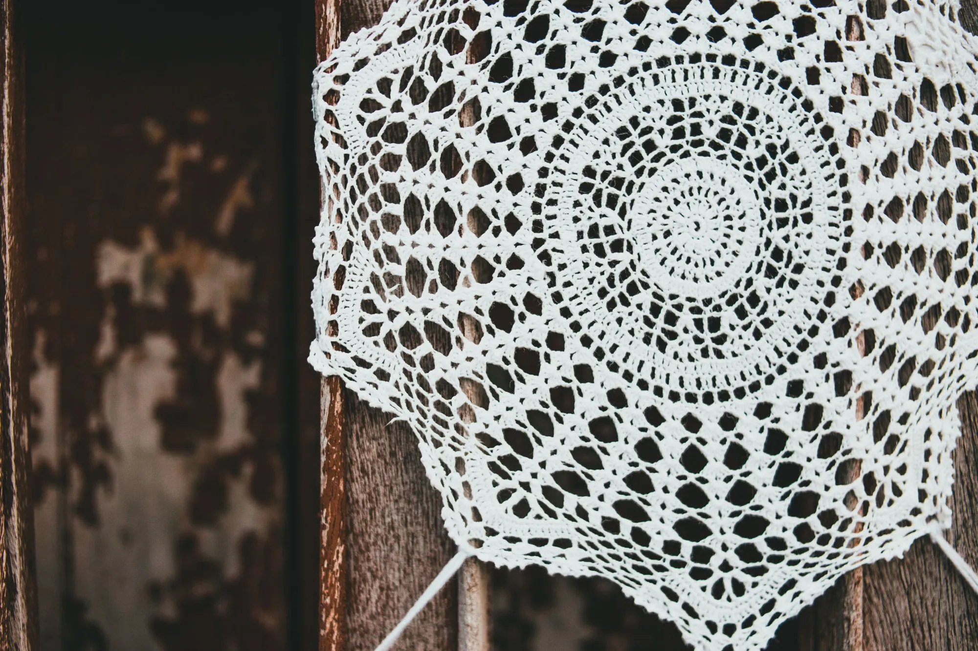 A crochet doily in white cotton thread — filet works the same mesh