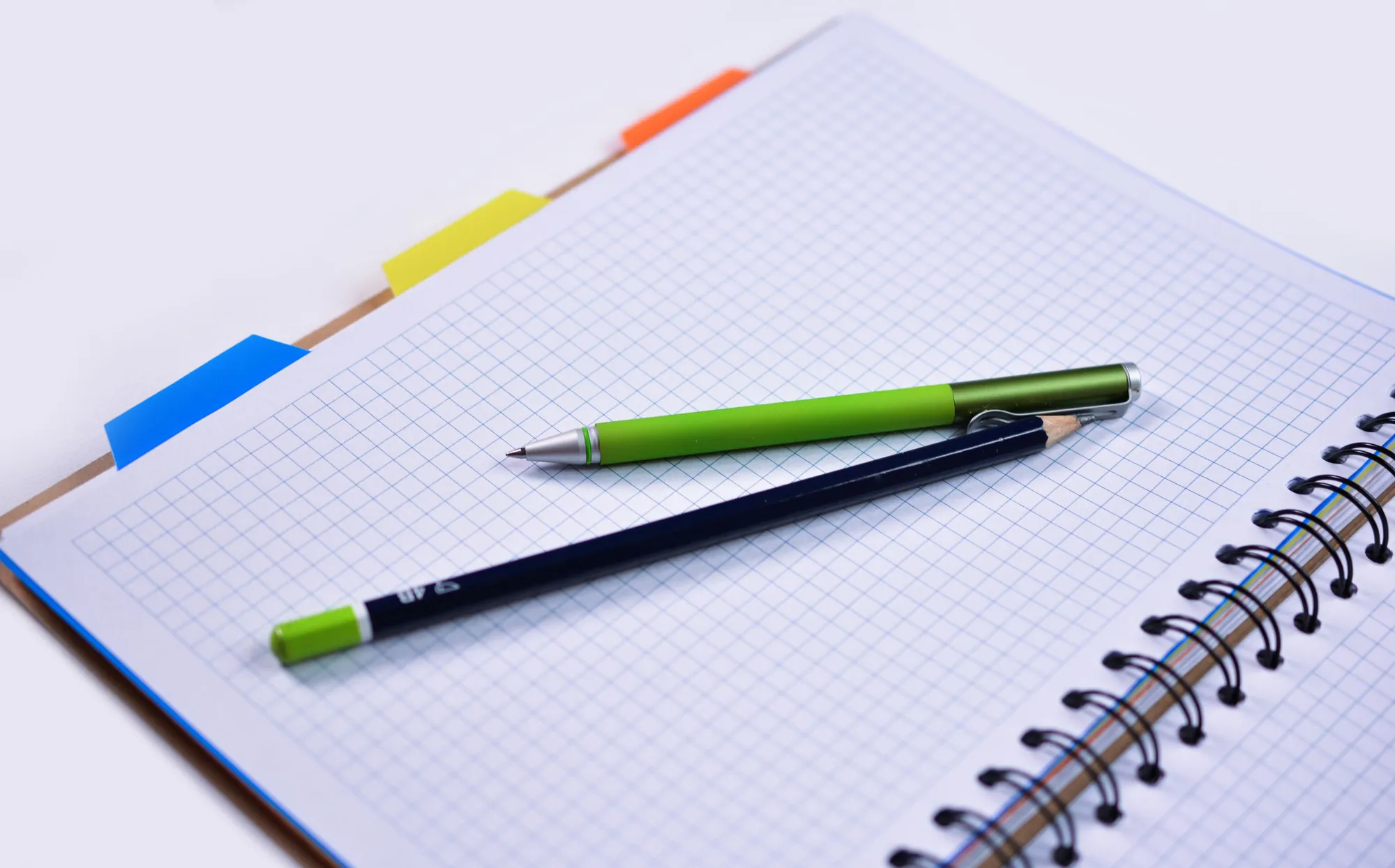 Graph paper and pencils — the original pixel art grid